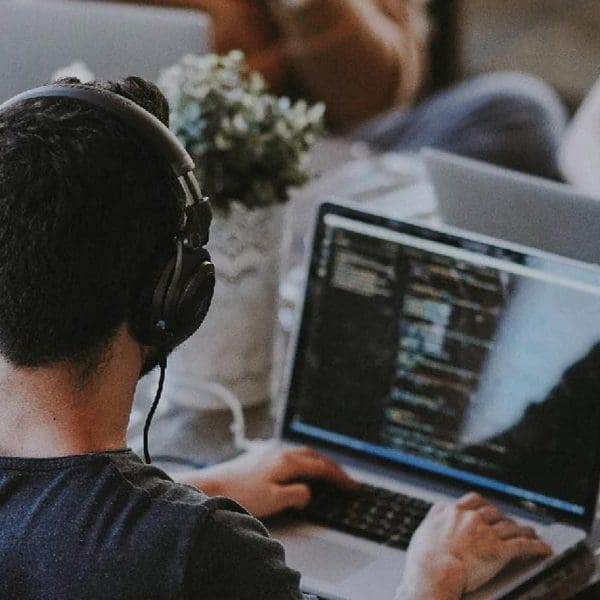 person with headphones developing a brand new website - Marketing Agency in Nashville, Brentwood, Franklin, & Spring Hill - Web Design company, digital marketing, SEO, and more - Business Web Design | JLB Works